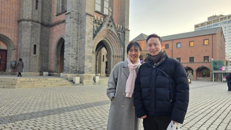 Kyle Jong and her fiancée Lucia Yu in front of Meonging Dong Cathedral in Seoul